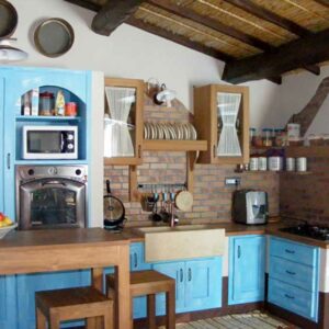 country-style built-in kitchen in exposed stone