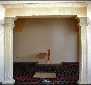 Cladding for a wall with a faux stone arch